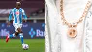 Super Eagles star who can't stop scoring shows off expensive customised gold chain with photo of late parents