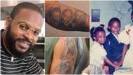 Falz shares videos as he tattoos throwback photos of parents, siblings on his arm