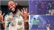 Chaos on stage as Davido's bouncers battle 2 stubborn fans who struggled and fought to hug him