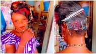 Nigerians react as young girl bedazzles hair with her name in trending video