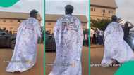 University graduate celebrates sign-out day with white 'agbada' and special inscription