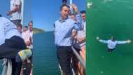 Teacher caught on tape playing with his students, jumps into river fully dressed, children scream & cheer