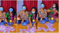 "She's calm": Lady cheats her man during blindfold money game, quickly fills her clothes with cash in video
