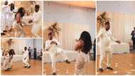 Bride pauses at wedding to catch a glimpse of her dad as he throws feet in the air, does fine legwork in video