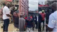 "How can I be part of this job?" Men gather around container of vehicles' spare parts, pray before opening