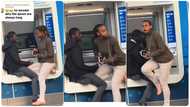 Couple losses themselves in conversation at ATM spot, queue piles up, lady reacts in video