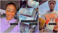 Young Nigerian lady keeps bundles of naira notes inside car, hands them to hawkers in viral video