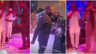Davido dances with KWAM 1 at Eniola Badmus' party, gives actress tight hug as she sprays both singers on stage