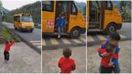 Kid stands on roadside, waits for elder brother, becomes joyous on seeing him come down from bus in video