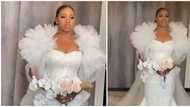 Saying 'I do' in puffy sleeves: Lovely bride stands out in style for her wedding