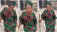 Jovial old woman in native wrapper dances with her walking stick, shakes body like teenager in viral video