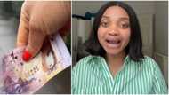 "Should I take it to the police?" Nigerian lady asks as she picks pounds on road in UK, shares video