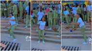Pretty corps member dances in white shirt & NYSC khaki trousers, man focuses on her in video