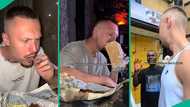 Nigerian lady brings her White partner to Nigeria for first time, video shows him eating suya, corn
