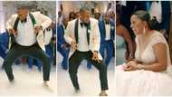 Handsome groom bends down low, uses his waist to dance like a lady, excited guests gather to watch in video