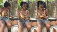 "You will make it in life": Super-cute Nigerian lady fries garri while eating roasted corn, video goes viral