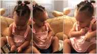 Baby takes money from a wallet, puts it inside her cloth like an adult, video stirs reactions