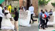 Lady in white dress storms street with her man, begs for money for their wedding, prank video trends
