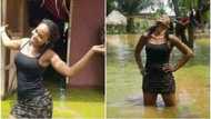 Girl poses in dirty water as flood takes over parts of Benue state (photos)