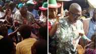 Former Governor Peter Obi pictured sharing money to traders ahead of Anambra governorship election