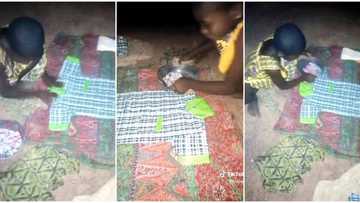 "The spirit of success": Little girl spotted using plate to iron her school uniform, touching video goes viral
