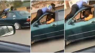 Nigerian policeman hangs for dear life on the roof of a speeding taxi driver’s car