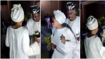 Make baba no fall o: Nigerians react as Alaafin Oyo parties hard with his young wife, sprays her naira notes