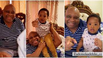 Davido’s uncle Senator Adeleke wears huge smile as he finally meets grandson for the first time