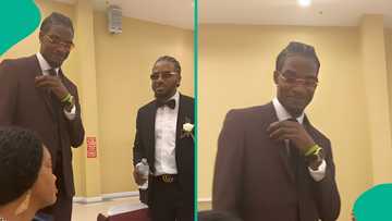 Nigerian mother reacts with disbelief as her two grown sons braid their hair