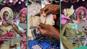 Bride's reaction trends as aso ebi lady stops elderly woman from spraying money on her face