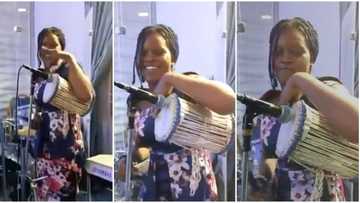 Yoruba talking drum makes beautiful noise, talented girl taps it with skillful hand, cute video causes stir