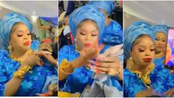 Risky doings: Bobrisky recreates Oba scene in video, sprays cash as Yinka Ayefele sings his praise