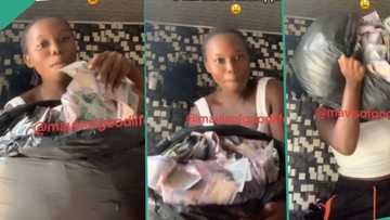 "I wan go buy land for village": Nigerian lady shows off money she picked at club, fills them in bag
