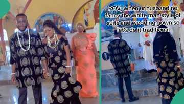 Lady and her husband wear Isi Agu' traditional dresses for their white wedding