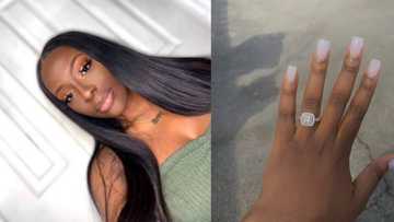 Young lady excitedly shows off new engagement ring after it was upgraded
