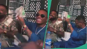 Wizkid hangs out with Kunle Afolayan, sprays bundles of cash as actor sings to him, fun video trends