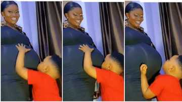 Video as little boy holds his heavily pregnant mother, plays with her big baby bump in heartwarming way