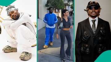 Asake raises eyebrows as he is spotted with a mystery lady in the US: "Who is she?"