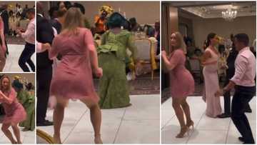 Pretty Oyinbo lady on short gown & heels twerks at small Nigerian wedding, guests paused to watch her in video