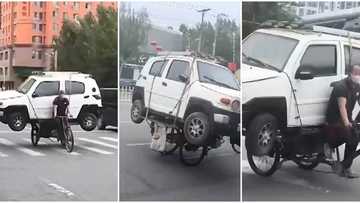 Man uses 3-legged bike to carry big car, rides around town in viral video, internet users react in surprise