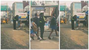 Moment Police Woman Was Seen Dressing Random School Children Wows Many, Photos Emerge