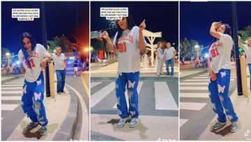 White man abandons wife, crosses road to watch pretty Nigerian lady dancing sweetly on road, video goes viral