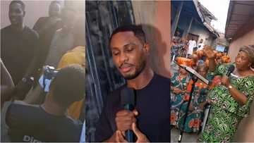 Fanfare in Ajegunle as Super Eagles striker buys house widows, gives them huge cash gifts