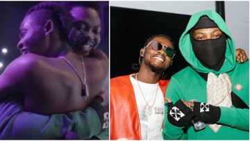 Heartwarming moment Omah Lay jumped on Olamide on stage, kneels to pay homage to senior colleague