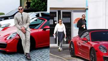 Savage: Alex Rodriguez proudly poses next to expensive red Porsche he had gifted J Lo