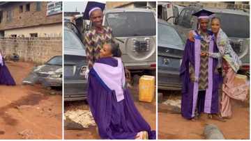 Female graduate runs to her father's mechanic workshop, hugs and dresses him in her graduation clothes in clip