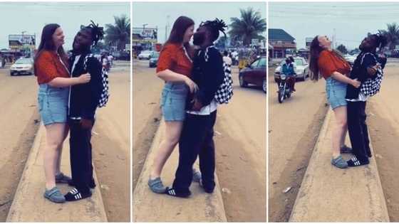 "God don butter my bread": Nigerian man causes stir in public, kisses Oyinbo lady, then shouts loudly in video