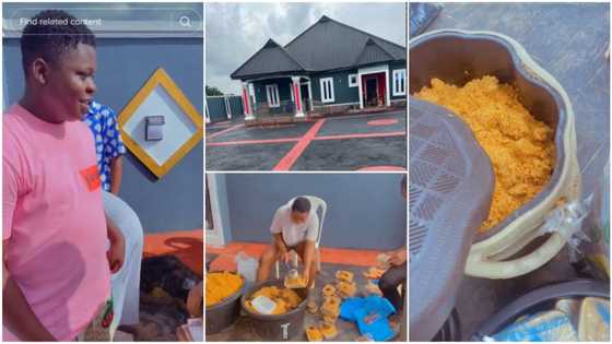 Young man builds colourful house with black roof, interlocks compound, cooks pot of jollof rice to celebrate