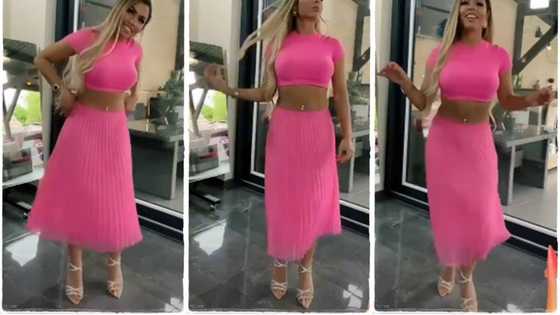 Beautiful lady in pink outfit shows off gentle dance moves, slowly shakes her waist in cute video