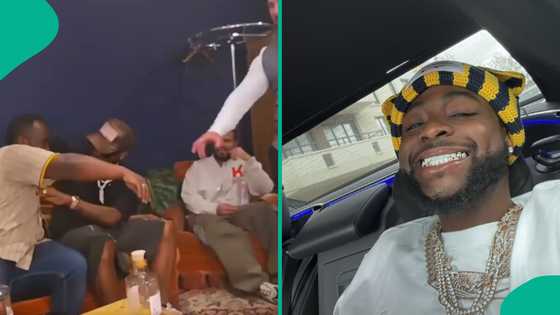 Davido queries overzealous male fan while taking photo with him: “Do you want to kiss me?”